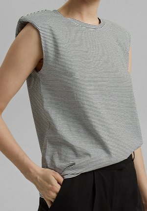 Top senza maniche a righe bianco e nero, realizzato in tessuto morbido, con scollo rotondo e vestibilità comoda con spalle abbassate.