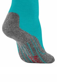 Türkis- und grauer Socken mit einer strukturierten Oberfläche, der ein markantes Fersendesign und rote Akzentdetails auf der Sohle aufweist.