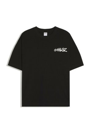 T-shirt noir à manches courtes avec logo texte blanc « Gorillaz » sur la poitrine gauche et col rond.