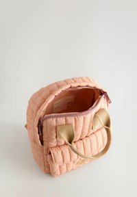 Quilted pink backpack with a zippered opening, beige fabric handles, and a front pocket. Smooth texture and subtle stitching detail.