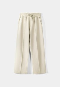 Béžové kalhoty s širokými nohavicemi, elastickým pasem a šňůrkou, vybavené dvěma bočními kapsami a hladkou, měkkou texturou. Jednoduchý design.