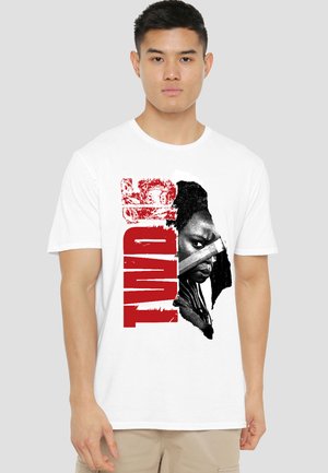 Young man wearing a white T-shirt with red vertical "TWD" text and a black-and-white intense face holding a knife graphic.