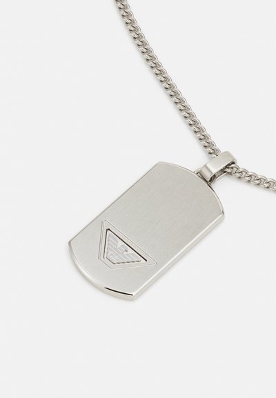 Silver metal dog tag pendant with a brushed finish, featuring a triangle logo and a chain with a twisted design.