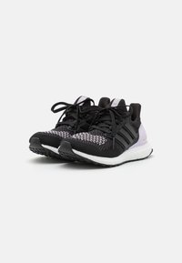 Black and purple athletic shoes with a textured knit upper, sturdy black accents, elongated white sole, and black rubber outsole.