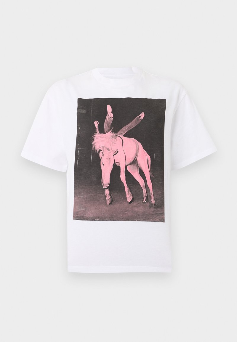 Maglietta bianca con una grafica di una persona appesa a testa in giù su un cavallo, entrambi tonalità rosa su uno sfondo scuro.