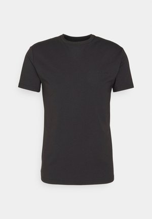 Black cotton t-shirt, crew neck, short sleeves, featuring a subtle logo on the chest. Smooth texture, regular fit, and simple design.