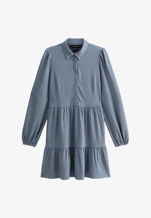 Blue long-sleeve shirt dress with a button-down front, collar, and tiered ruffled hem. Made from textured fabric, featuring a relaxed fit.