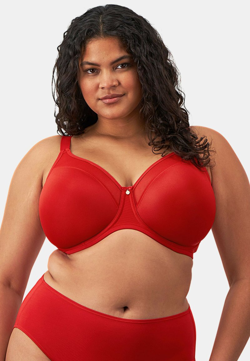 Reggiseno rosso con ferretto, realizzato in tessuto morbido e elasticizzato. Presenta leggera imbottitura, spalline regolabili e un piccolo dettaglio decorativo al centro.