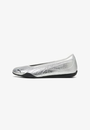 Ballerina piatta metallizzata argento con logo Puma nero sulla punta e suola nera, pensata per un uso casual o sportivo.