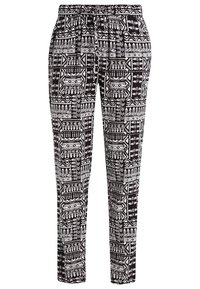 Pantalon à motifs noir et blanc avec une taille élastique, présentant des dessins géométriques et une coupe fuselée. Tissu léger.