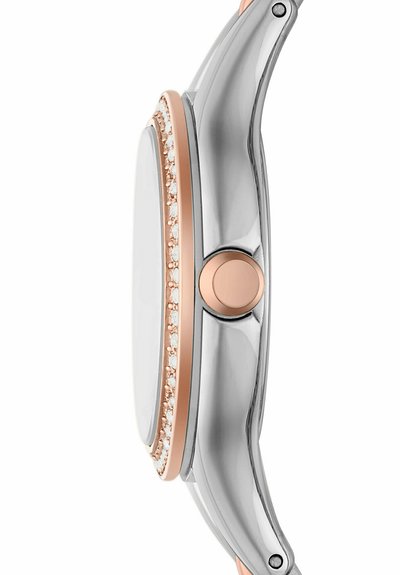 Metallic watch featuring a silver casing with rose gold accents and a crystal-studded bezel; smooth, rounded shape.