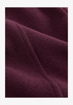 Tessuto in maglia di un profondo colore borgogna, caratterizzato da un pattern testurizzato a coste con dettagli morbidi e pelosi.