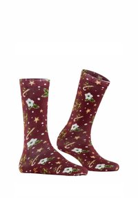 Calze marroni con un design festivo caratterizzato da fiori bianchi, foglie verdi, stelle dorate, bastoncini di zucchero e pois bianchi.