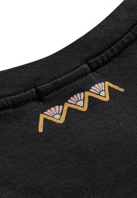 Black cotton fabric with a ribbed neckline. Features a colorful embroidered design of pink flowers and zigzag patterns in yellow and green.