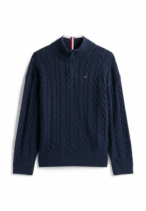 Pull bleu marine en maille torsadée avec col zippé moitié, poignets et bas côtelés, petit logo rouge, blanc et bleu sur la poitrine.