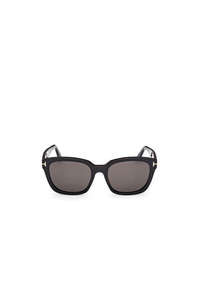 Lunettes de soleil noires avec une monture rectangulaire épaisse, des verres foncés et de subtils accents dorés sur les branches, présentant une texture en plastique lisse.