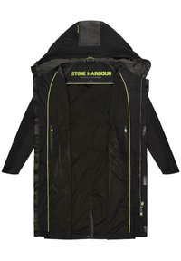 Svart vattentät jacka med fluorescerande gula detaljer, helgängad design, dragkedjefickor och huva med dragsko. Innehåller ett märkt inre.