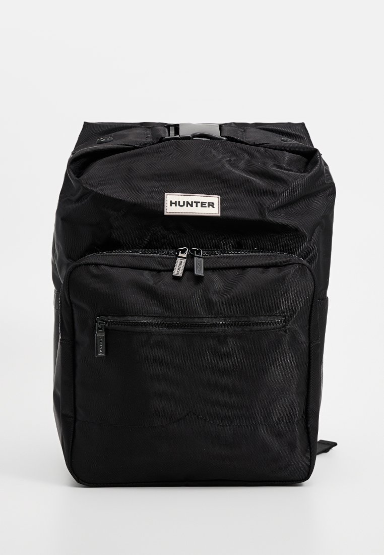Schwarzer Nylon-Rucksack mit rechteckiger Form, ausgestattet mit einem oberen Griff, einer vorderen Reißverschlusstasche und einem kleinen Etikett mit dem "HUNTER"-Logo.