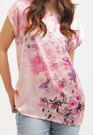 Light pink satin blouse with floral print in shades of pink and purple, featuring a loose fit, short sleeves, and a rounded neckline.