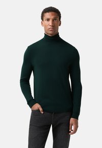 Dark green turtleneck sweater made of a smooth knit fabric. Fitted design with long sleeves and ribbed cuffs and hem.