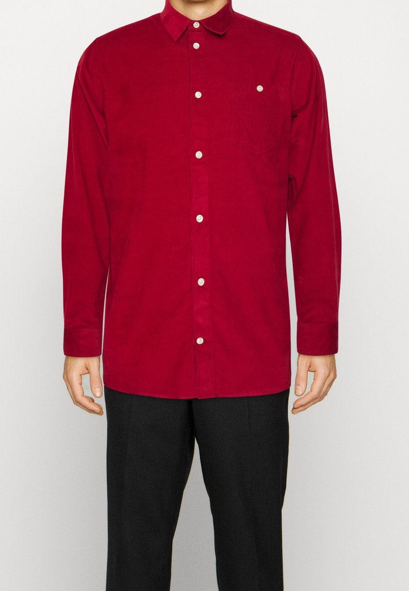Czerwona koszula na guziki z długimi rękawami, kieszenią na piersi i białymi guzikami. Charakteryzuje się miękką tkaniną i klasycznym kołnierzykiem.