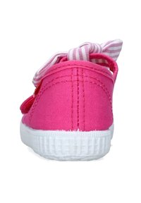 Sneaker in tela rosa con suola in gomma bianca, nastro a righe rosa e bianco, e dettagli di cucitura visibili sulla parte superiore.