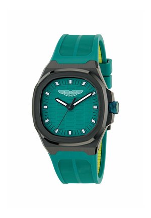 Groene blauwe horloge met een hexagonaal patroon op de wijzerplaat, zwarte kast en een gestructureerde groene siliconen band. Witte uurmarkeringen en wijzers, logo op 12 uur.