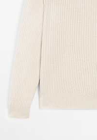 Maglione a coste di colore crema, con maniche e lati che mostrano i dettagli del tessuto testurizzato e dei polsini su uno sfondo bianco.