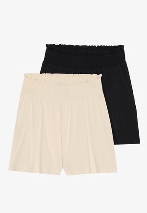 Deux paires de shorts relaxes : une couleur crème et une noire, toutes deux dotées de ceintures élastiques à volants et en tissu doux et léger.