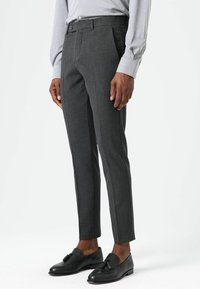 Grijze op maat gemaakte broek in een gestructureerde stof, met een vlak voorfront, twee zijzakken en een slanke, taps toelopende pasvorm. Voorzien van een knoopsluiting.