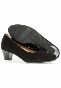 Black suede pumps with a rounded toe and a mid-height block heel. The textured rubber sole features floral and leaf patterns.