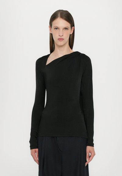 Black long-sleeve top with a draped neckline and asymmetrical shoulder detail, crafted from a smooth, stretch fabric.