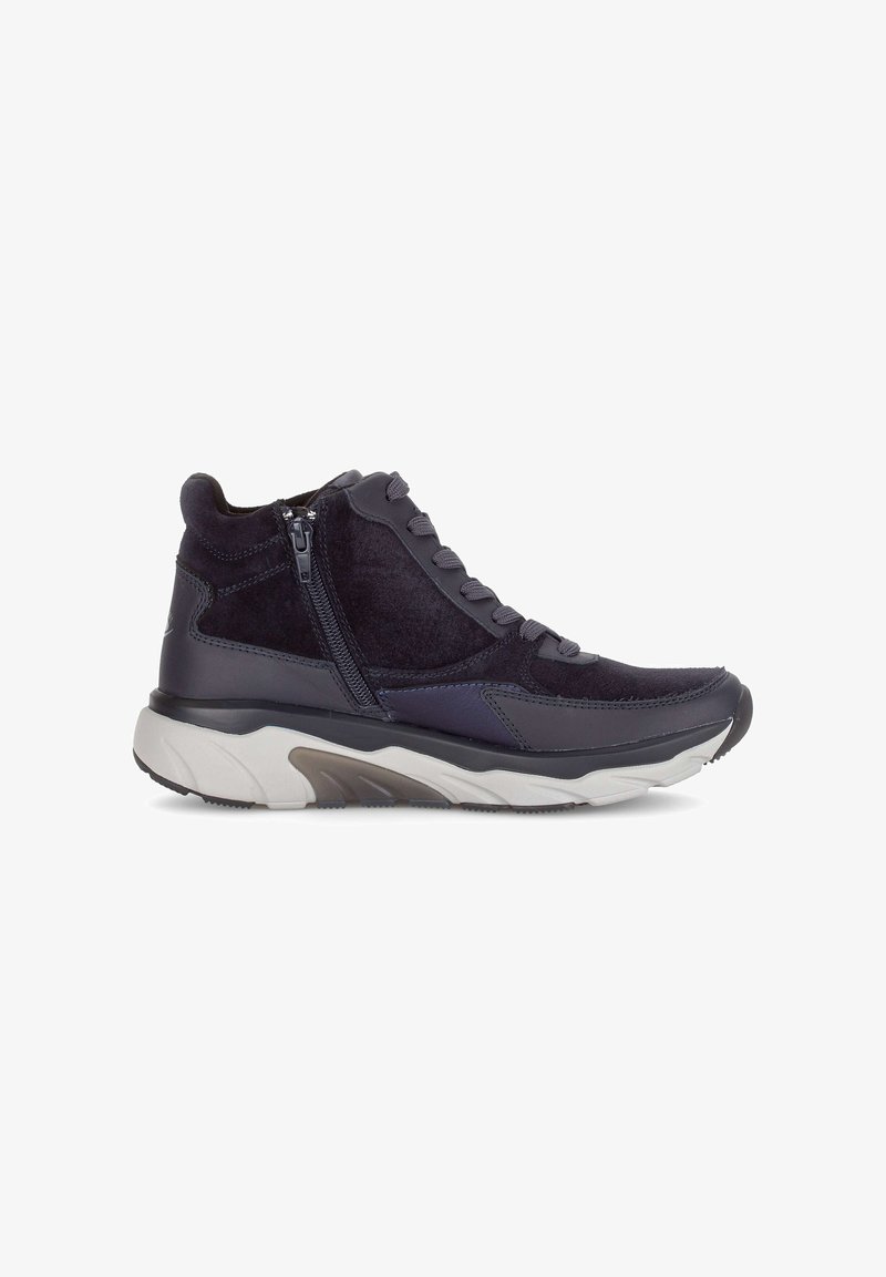 Mid-top sneaker in dark navy suede and synthetic material, featuring lace and zipper closure, and a chunky white and gray sole.