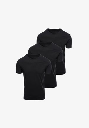 Trois t-shirts noirs unis à manches courtes et col rond, disposés en pile verticale décalée sur un fond blanc.