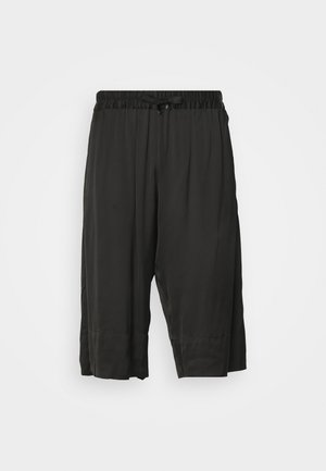 Black cropped trousers with an elastic waistband and drawstring. Made from a smooth, lightweight fabric with side seams for a relaxed fit.