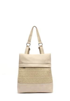 Beige tote bag with woven texture center panel, smooth leather top flap, base, and adjustable shoulder straps.
