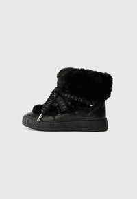 Black faux fur ankle boots feature a high shaft, textured surface, logo-embossed sole, and ribbon laces with brand lettering.