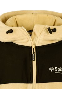 Giacca con cappuccio foderata in pile, con parte superiore beige e parte inferiore nera. Presenta una zip anteriore, cappuccio regolabile e dettaglio del logo sul petto.