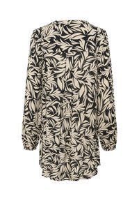 Blouse noire et crème avec un motif de feuillage, manches longues avec des poignets élastiques et un ourlet arrondi. Tissu léger avec une coupe décontractée.