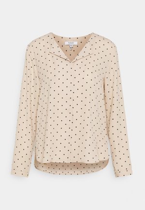 Beige langærmet bluse med sorte polkaprikker, en notched krave og en let buet kant.
