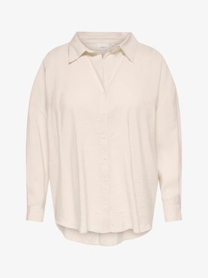 Loose-fit long-sleeve cream button-up shirt with pointed collar and slightly curved hem, made from lightweight fabric.