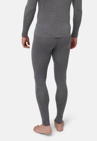 Graue enganliegende Leggings mit weicher Textur und Nahtdetails, hergestellt aus dehnbarem Material, die knapp oberhalb des Knöchels enden.