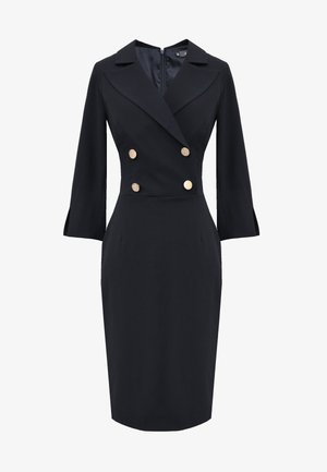 Dwurzędowa czarna sukienka z klapami, złotymi guzikami, rękawami o długości trzech ćwiartek oraz dopasowaną sylwetką zwężającą się na wysokości kolan.