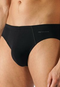 Slip in cotone nero con design senza cuciture, caratterizzato da una forma aderente e minimi dettagli di cucitura. Logo visibile sull'elastico.