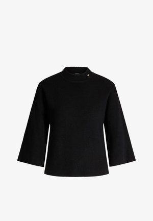 Black knit sweater with a high neckline, three-quarter sleeves, and a small gold accent on the shoulder. Textured fabric.