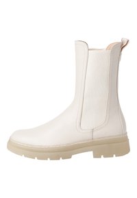 Botas blancas hasta el tobillo con paneles laterales elásticos, parte superior sintética suave, acabado texturizado y suela de goma translúcida, con costuras reforzadas.
