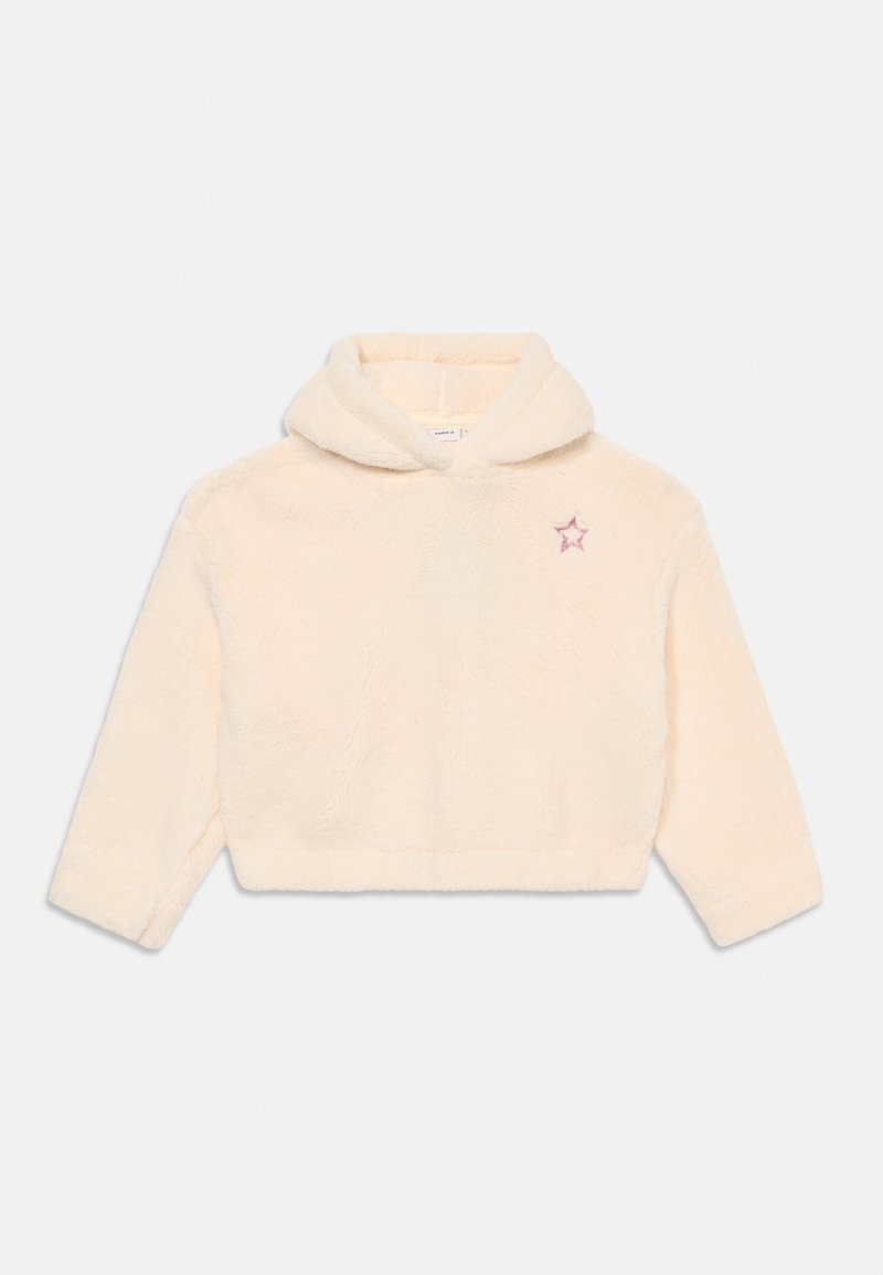 Sweat à capuche duveteux de couleur crème avec des manches longues et une petite étoile rose brodée sur le haut gauche de la poitrine.