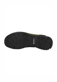 Suela de zapato de goma negra con un patrón de suela resistente, que presenta picos multidireccionales para tracción y un área central lisa.