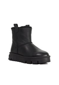 Black leather ankle boot with a textured finish, featuring a soft fur lining, a pull tab, and a thick, serrated rubber sole.
