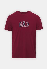 T-shirt en coton bourgogne avec col rond et manches courtes, avec le logo "GAP" en broderie blanche et marine sur la poitrine.
